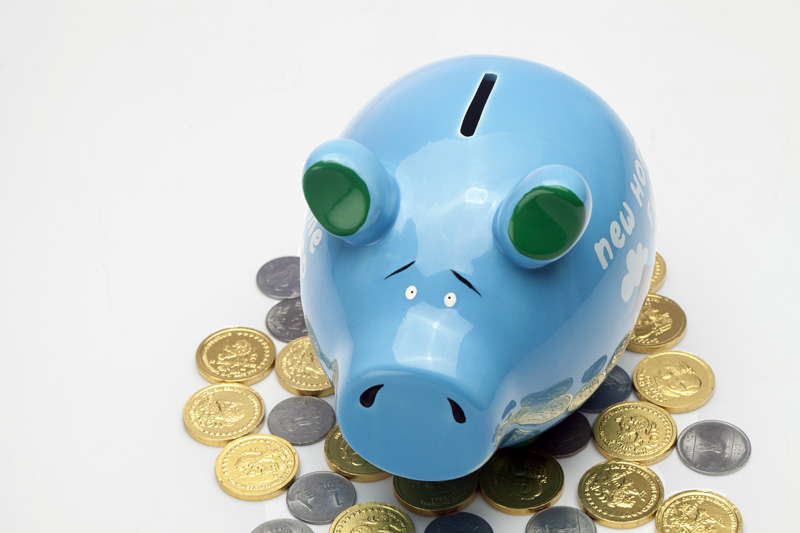 piggy bank with coins around 