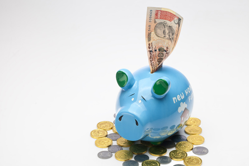 piggy bank with note and coins on white background 