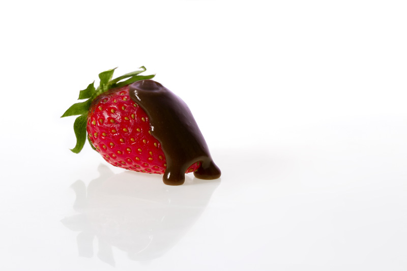 picture of strawberry with poured chocolate syrup