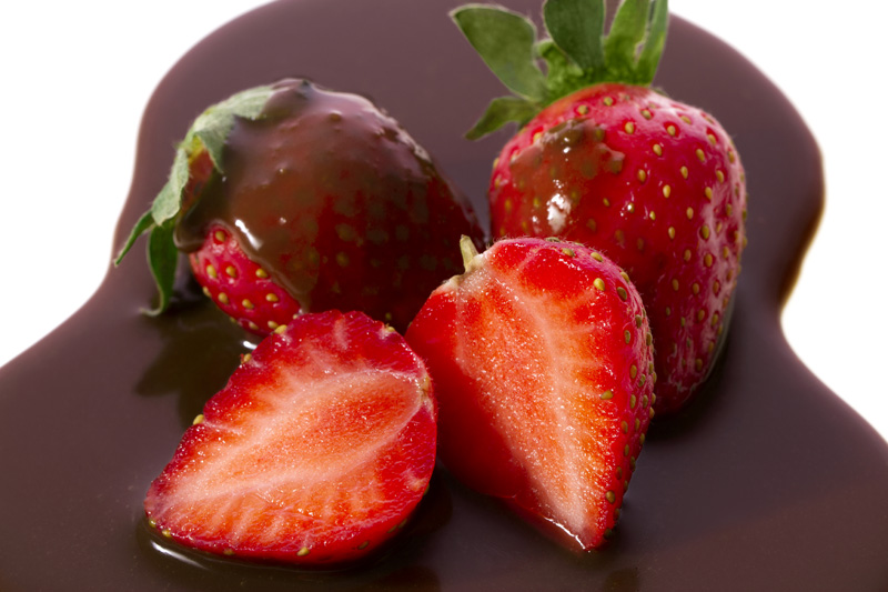 close up shot of strawberries flavored with chocolate syrup