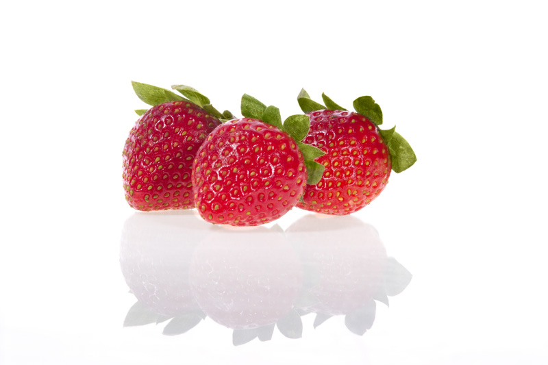 three strawberries shot against white background