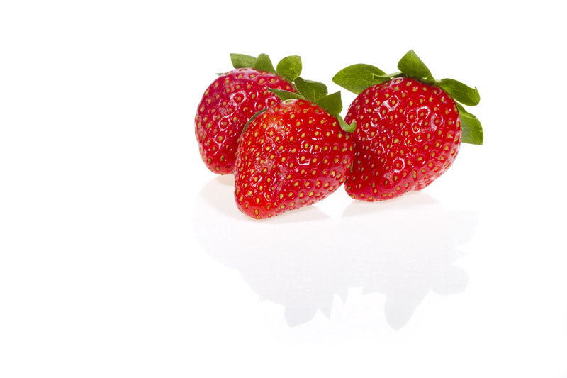 picture of three strawberries lying with copy space for advertising pu