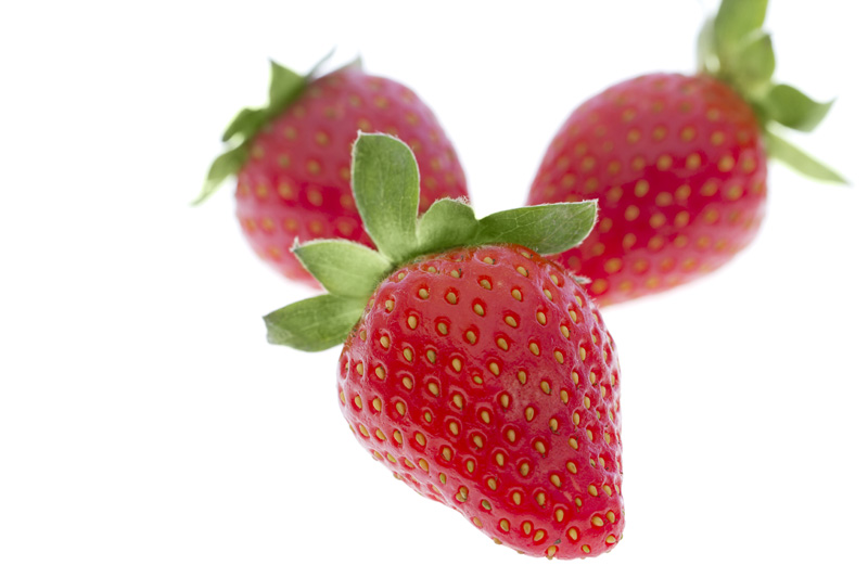 three strawberries against white background 