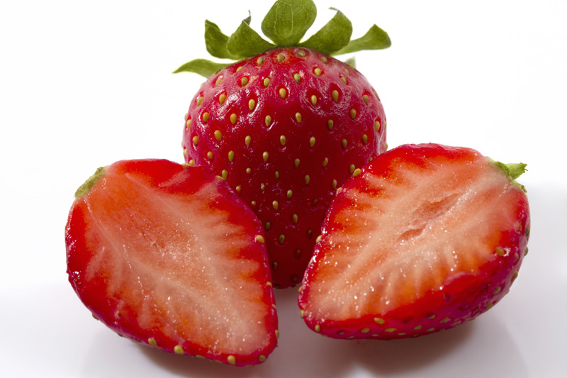 sliced strawberry against white background