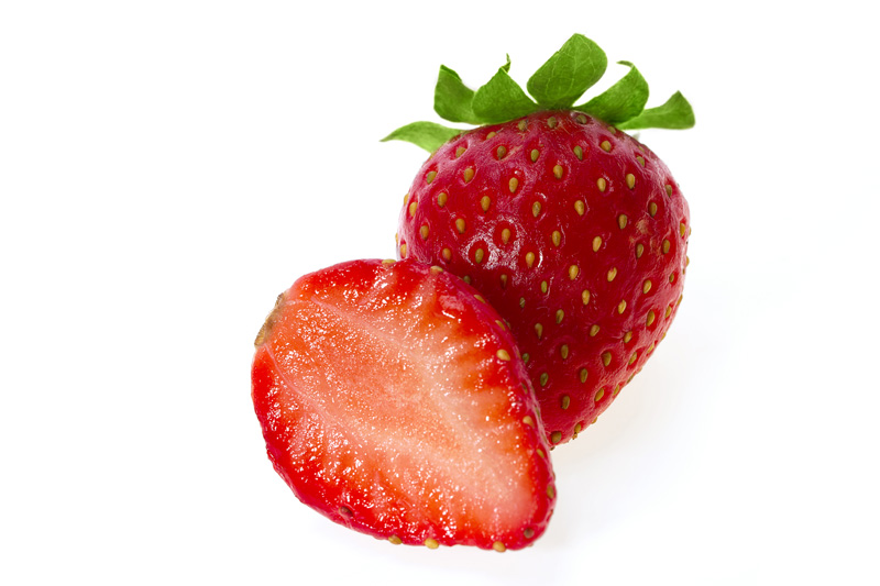 sliced strawberry on display against white background 