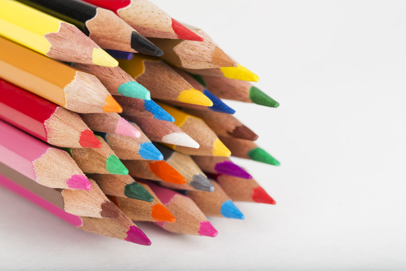 bunch of colourful pencils against white background 