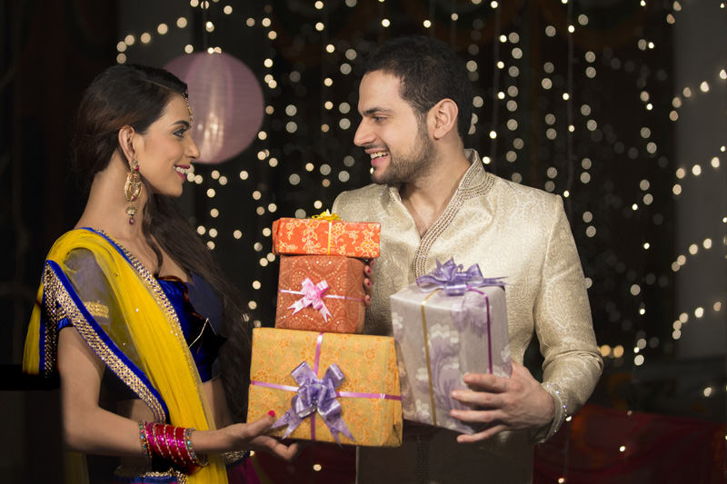 couple exchanging diwali gifts