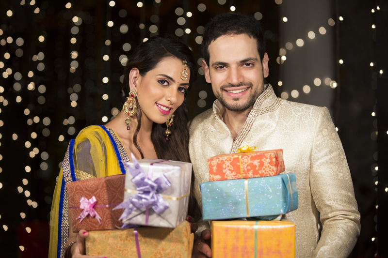 couple posing with diwali gifts