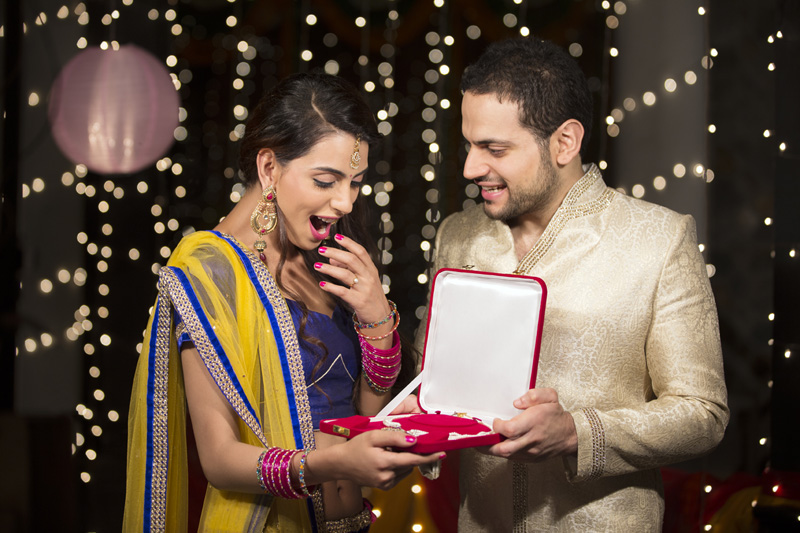 man giving jewellery to his wife 