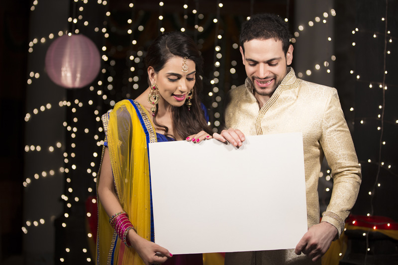 couple posing with a message board on diwali