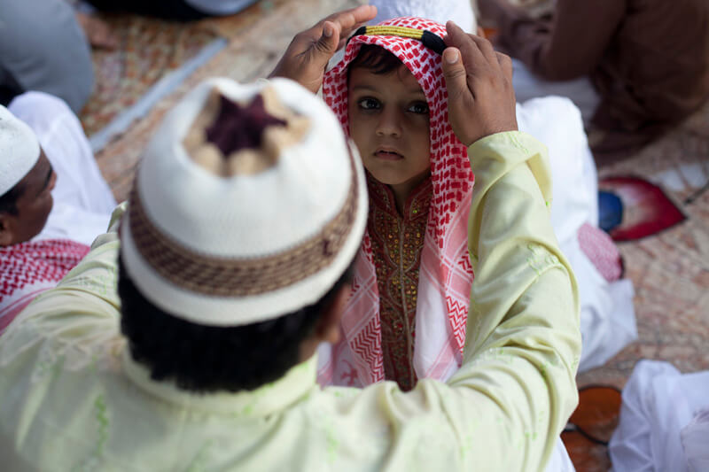 child with father at mosque 