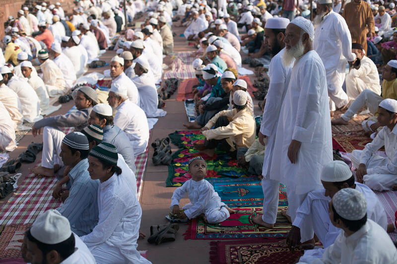 men attending eid prayer meeting at jama masjid 
