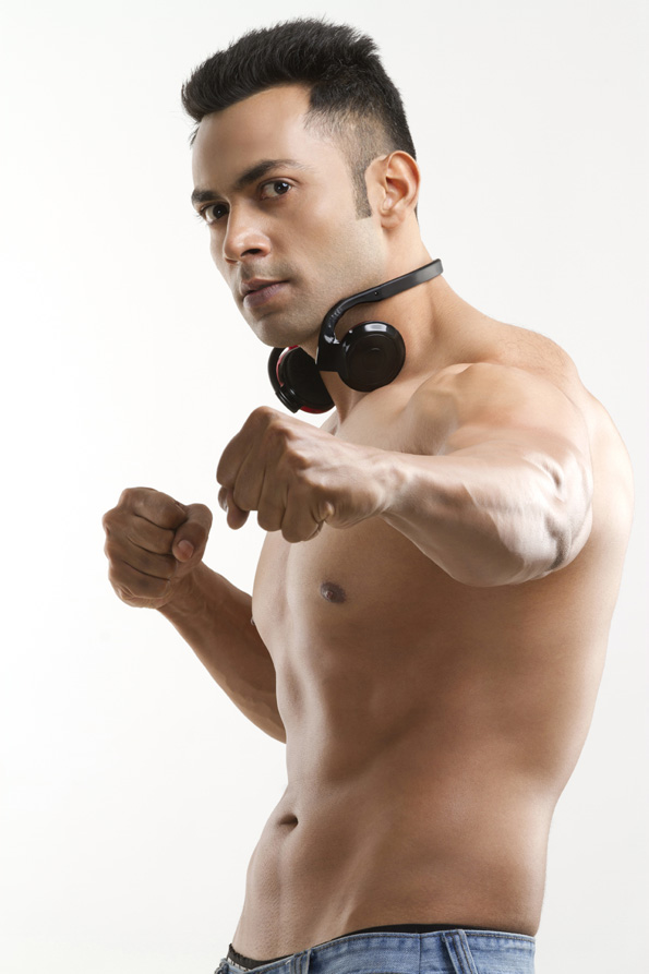 bare-chested male posing with headphones