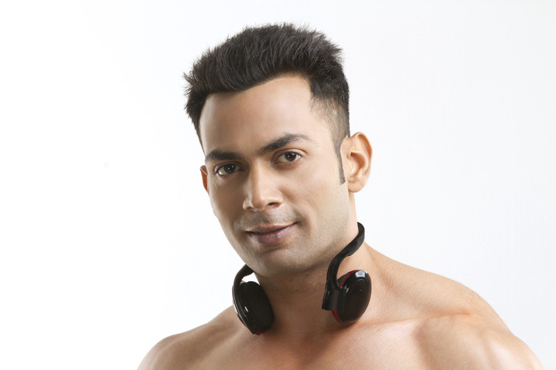 muscular man posing with headphones