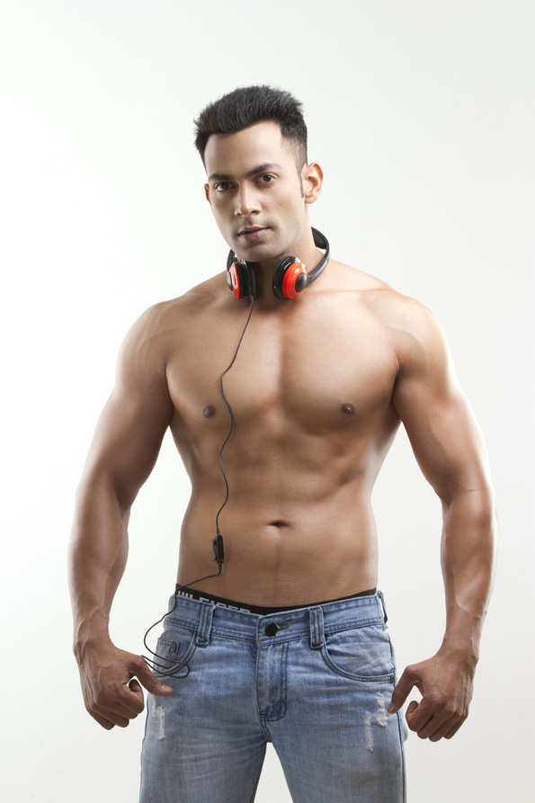 bare-chested male posing with headphones