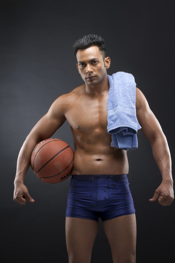 athletic man posing with basket ball