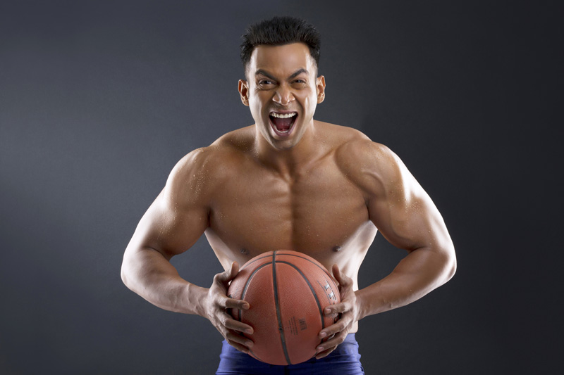 muscle man posing with a basketball