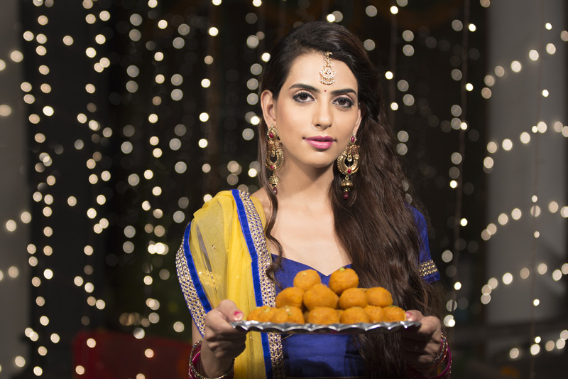 woman with a plate of ladoos