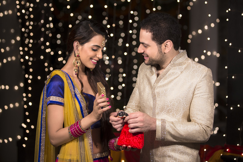 woman gifting husband a watch on diwali