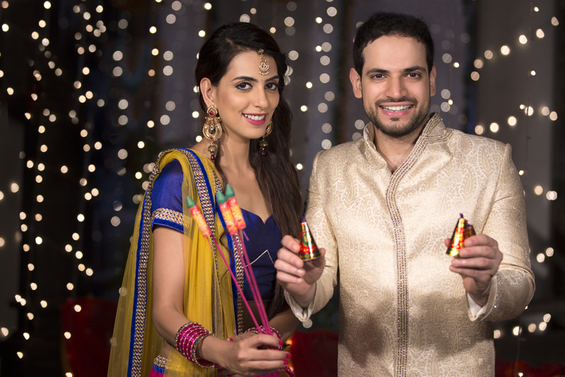 couple with crackers on diwali 