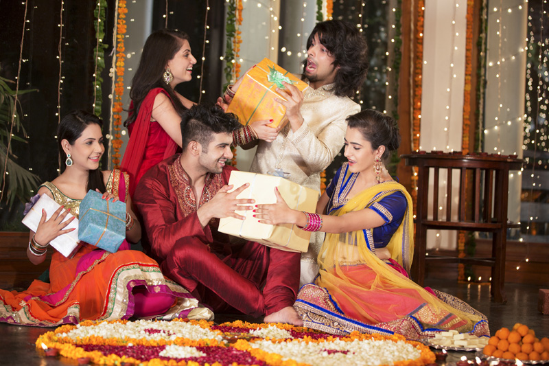 group of friends exchanging gifts on diwali