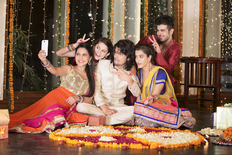 group of friends clicking photographs on festival