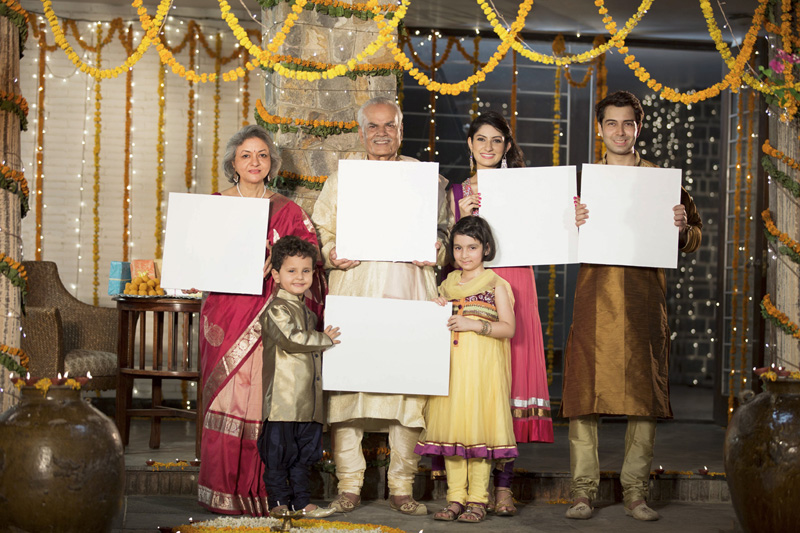 family standing at entrance with message boards on diwali