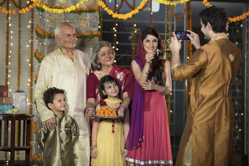 family clicking pictures on diwali 
