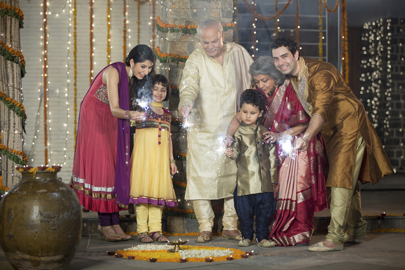 family celebrating diwali with crackers 