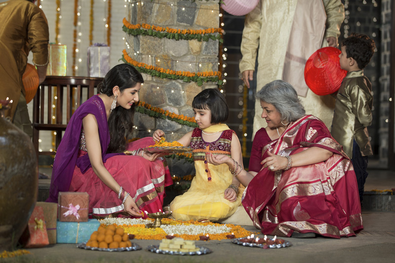 family celebrating diwali and doing pooja