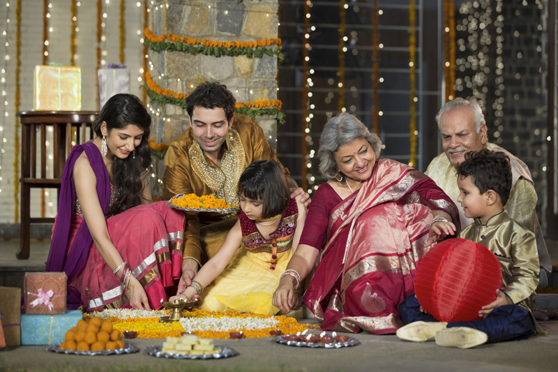 family celebrating diwali and doing pooja