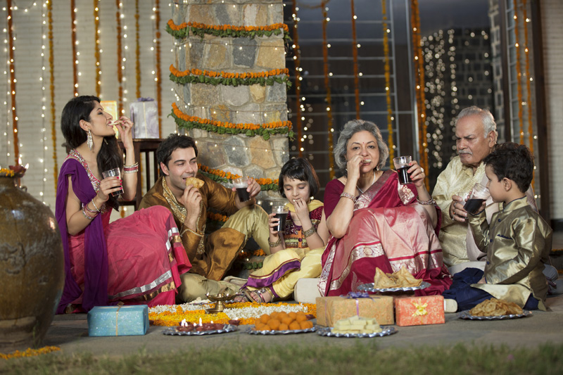 whole family sitting for diwali pooja