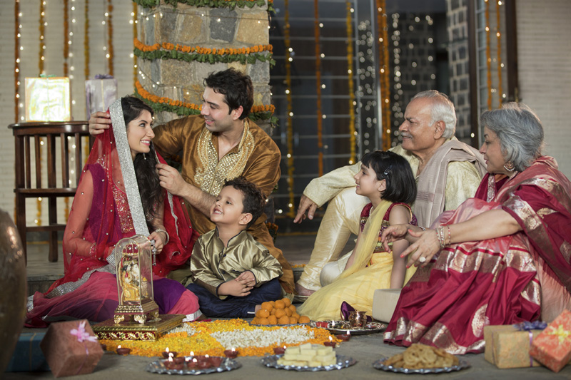 whole family sitting for diwali pooja