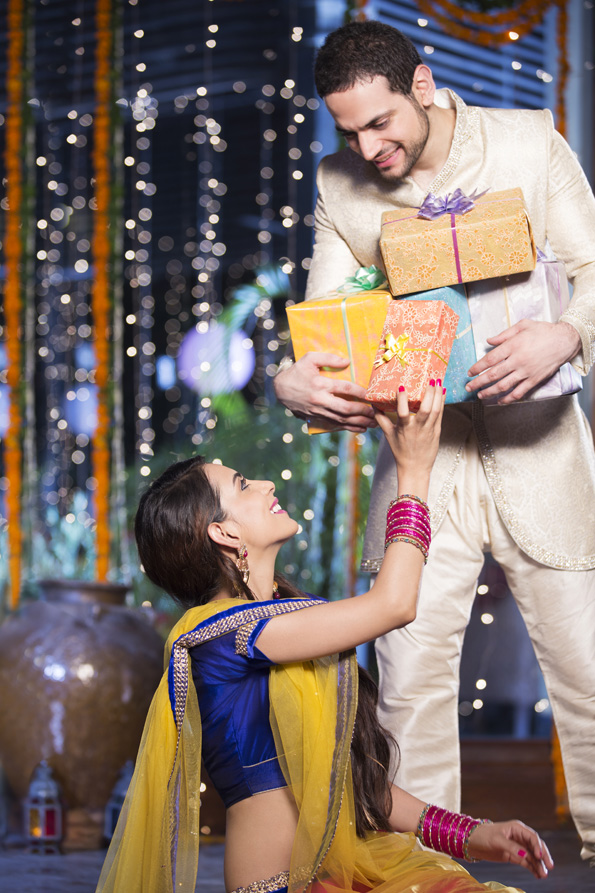 couple exchanging gifts on diwali 