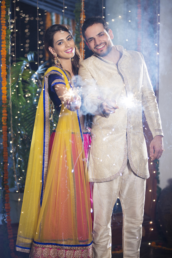 couple playing with sparklers on diwali 