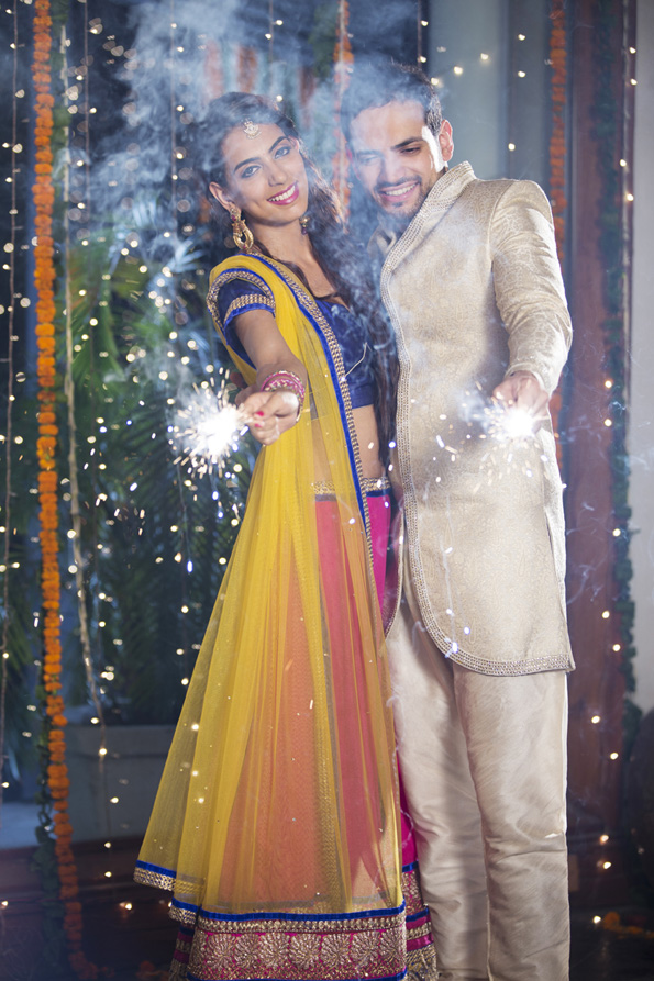 couple playing with sparklers on diwali 