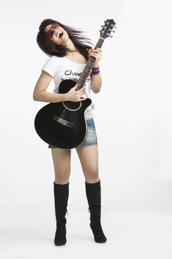beautiful teenager playing guitar on white background