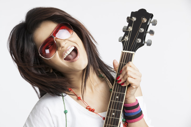 close-up of a girl playing guitar