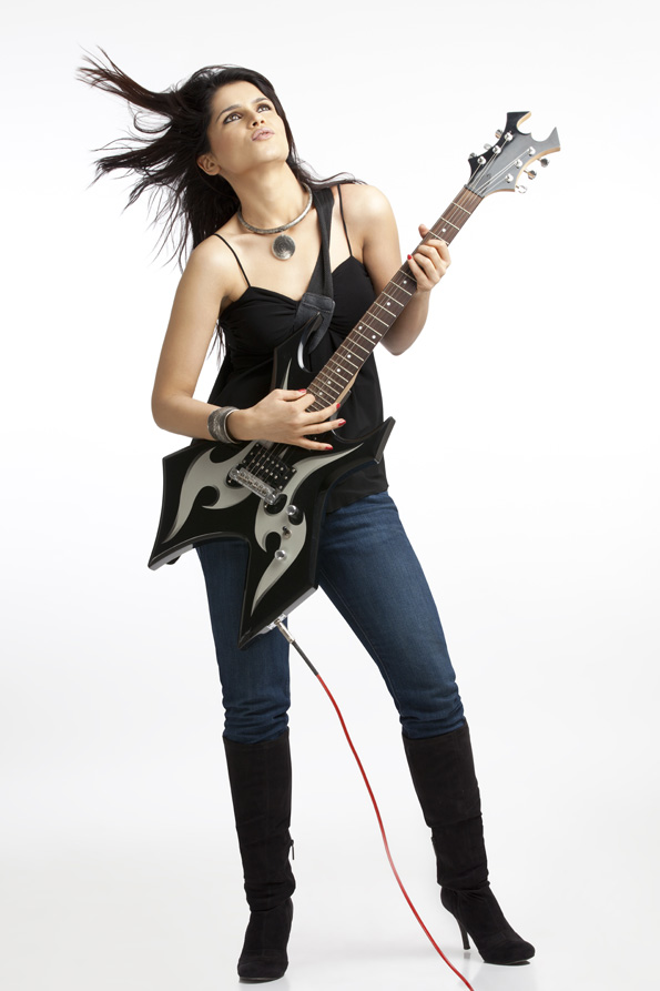 beautiful young female with electric guitar on white background