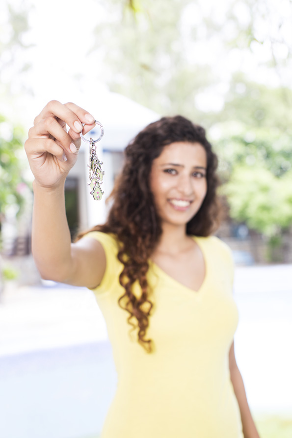 girl showing new home key
