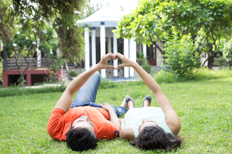 couple making heart shape with hands 