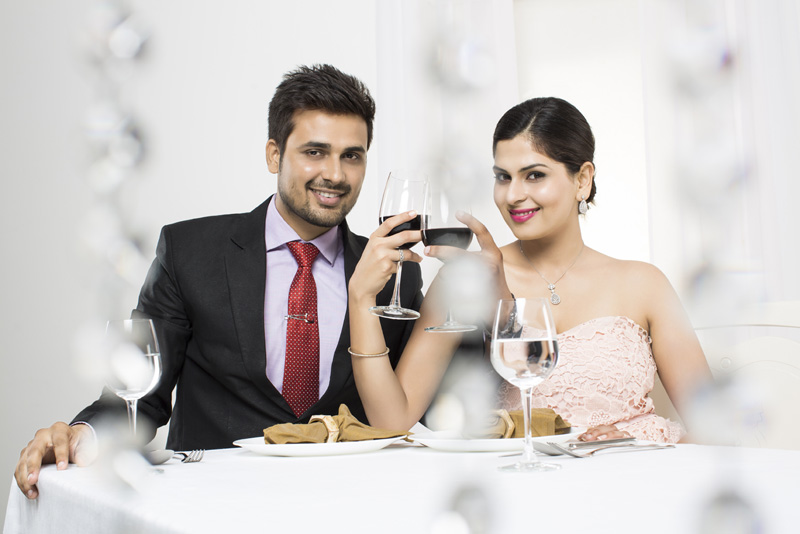 couple raising toast on romantic dinner 