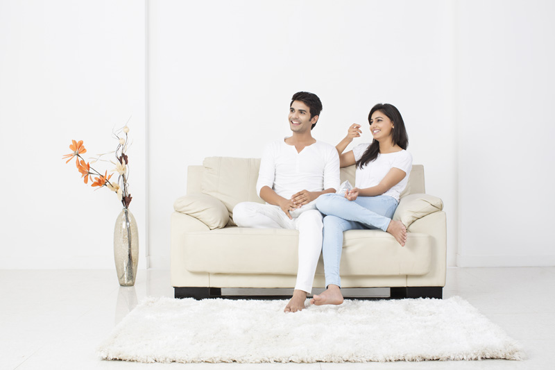 couple on couch smiling 