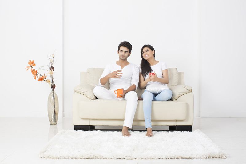 couple on couch having coffee