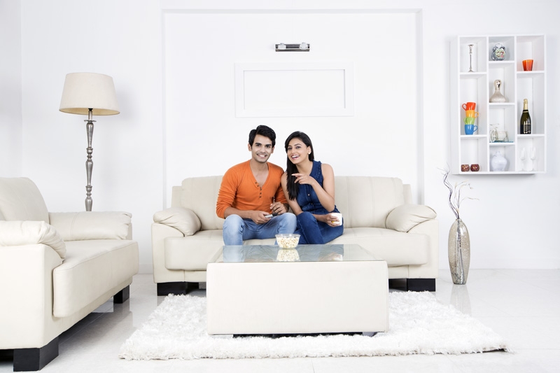 couple having popcorn while watching television
