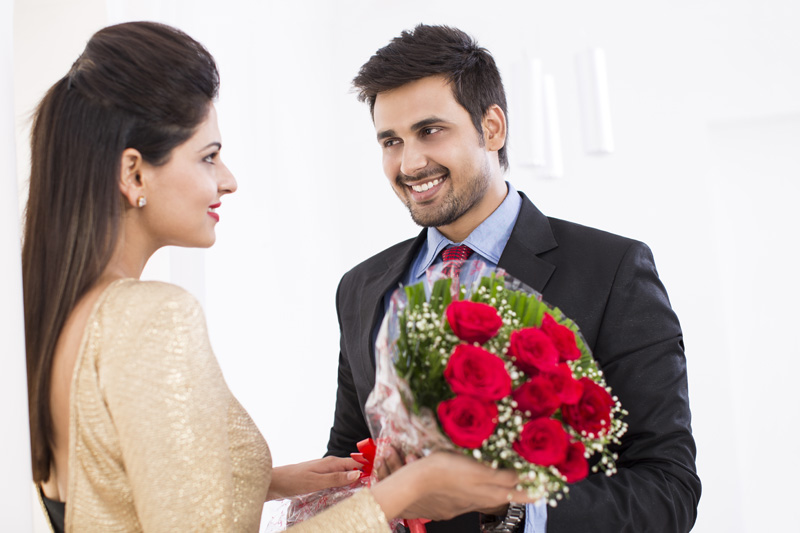 man proposing girl with bouquet 