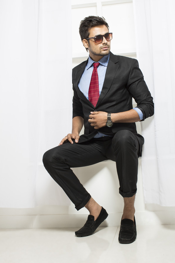 man in formals sitting and posing