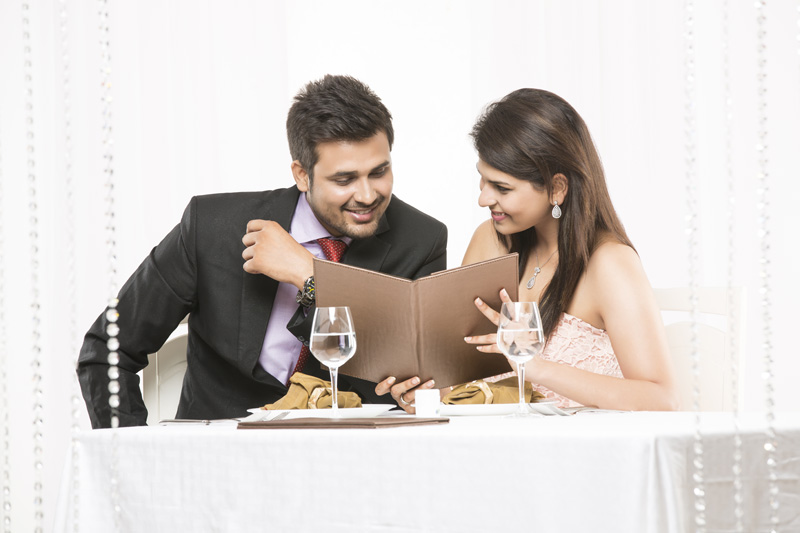 couple deciding the menu on romantic dinner date