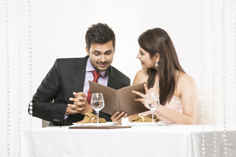 couple looking at the menu and smiling 
