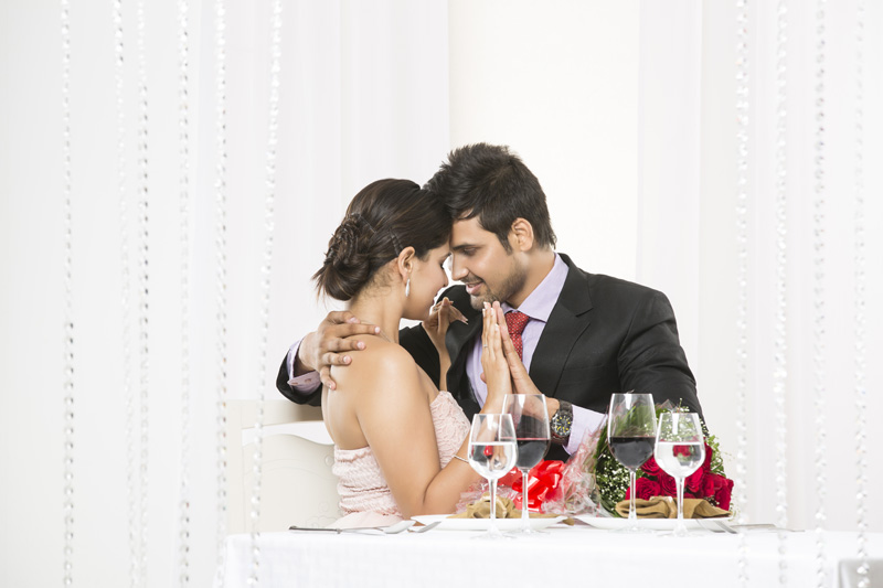 couple looking at each other while romancing on dinner date